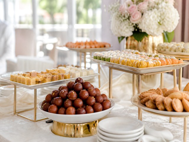 Modern birthday party table with desserts and festive catering details